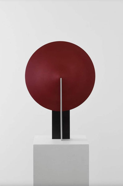 Orbe red table lamp on a side table