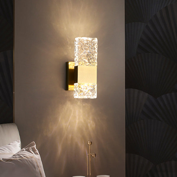 Frosted crystal wall light installed beside a bathroom mirror