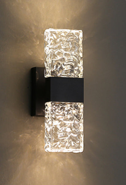 Frosted crystal wall light sconce mounted on a bedroom wall