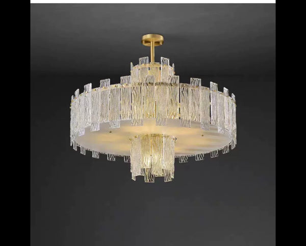 Close-up of Synfonia chandelier's brass and glass detailing