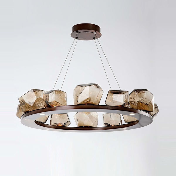 Diamond Cut Round Glass Chandelier with amber gold globes hanging in a Nigerian living room