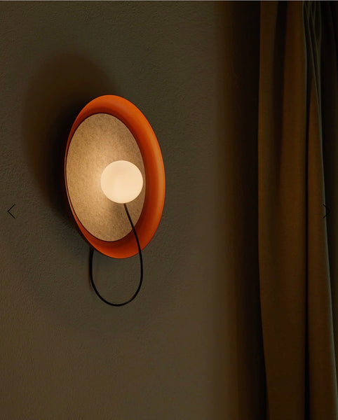 Acoustic Disc red wall light illuminated
