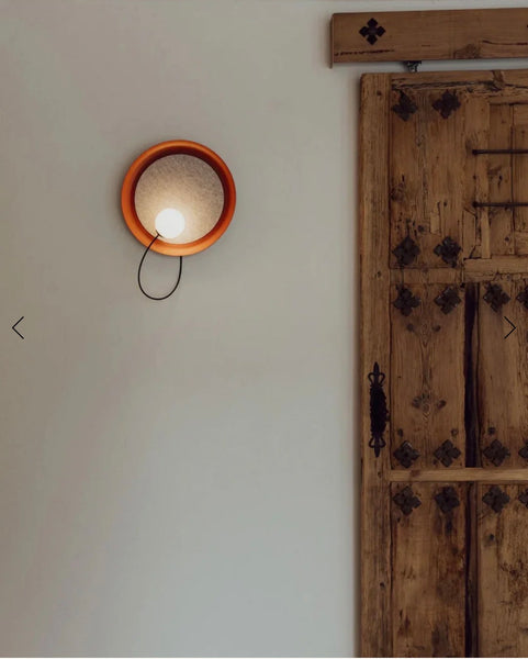 Close-up of Acoustic Disc red wall light's glass design