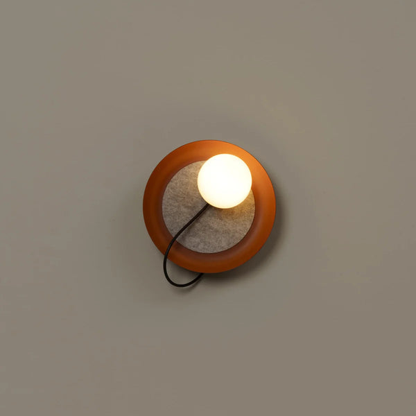 Acoustic Disc red wall light mounted on a wall
