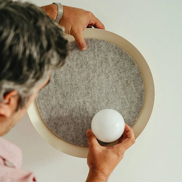 Close-up of Acoustic Disc white wall light's glass design