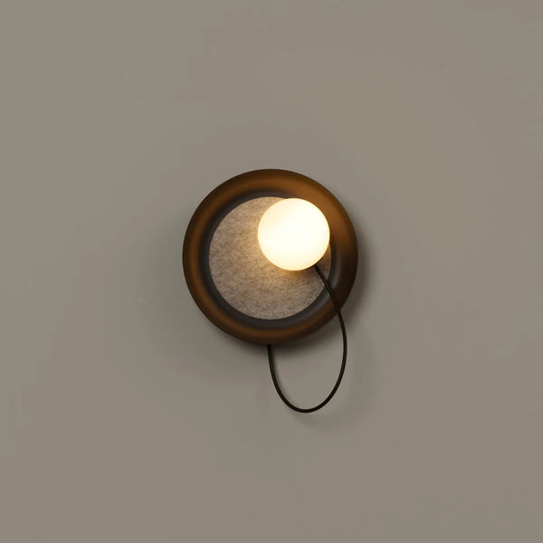 Acoustic Disc black wall light illuminated