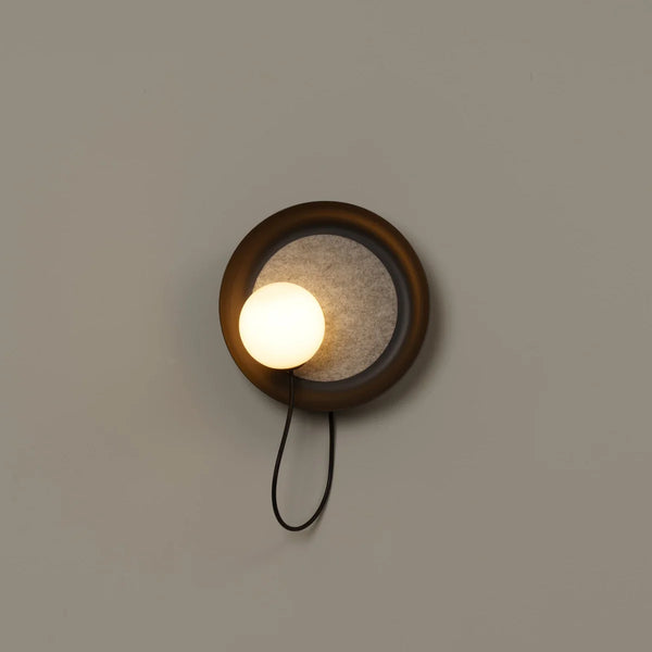 Close-up of Acoustic Disc black wall light's glass design