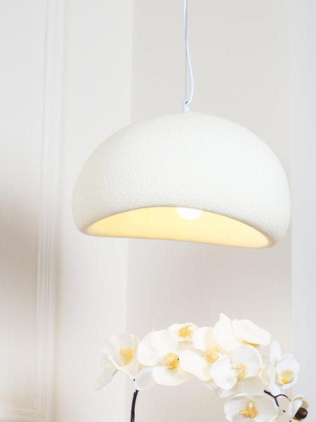 Wabi-Sabi white resin light illuminated in a living room