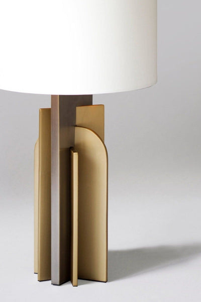 Icon table lamp with white cotton shade on a side table