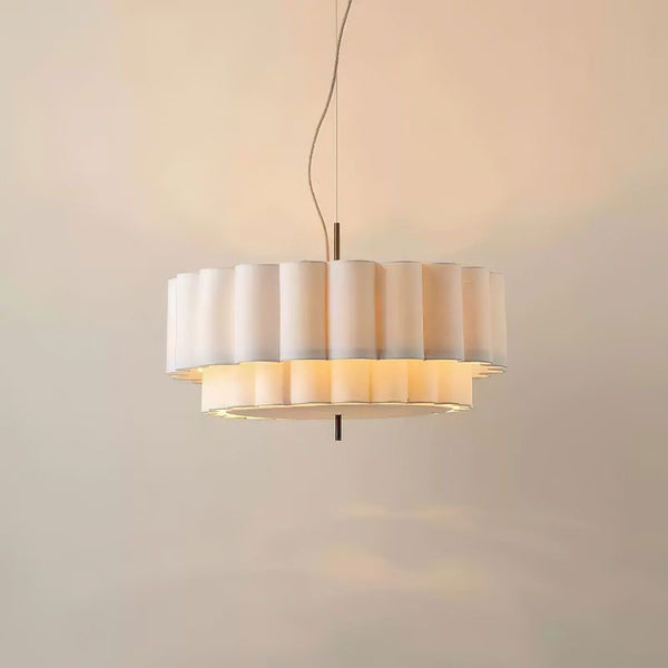 Folia Ripple Chandelier in linen and brass hanging in a Nigerian living room