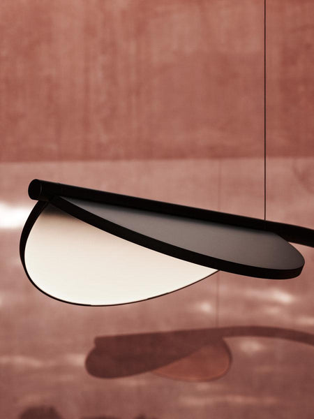Almendra Arc Suspension Light illuminated above a dining table in Nigeria