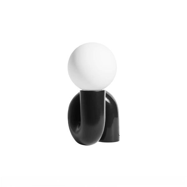 Tubular Neotenic Black Table Lamp styled on a bedside table in Nigeria