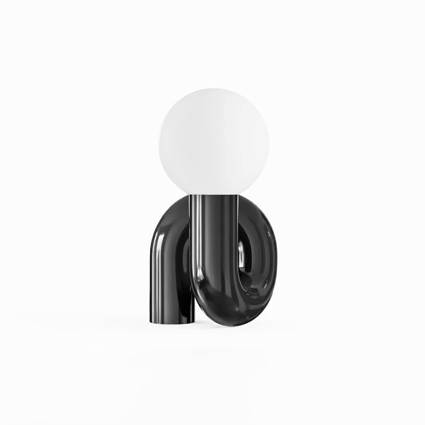 Tubular Neotenic Black Table Lamp illuminated in a Nigerian living room