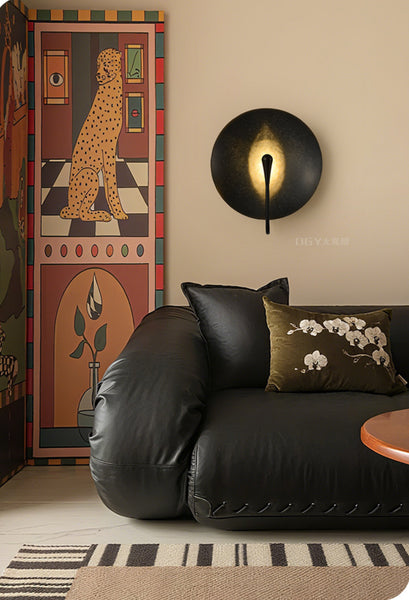 Alena black wall light illuminated with warm LED glow