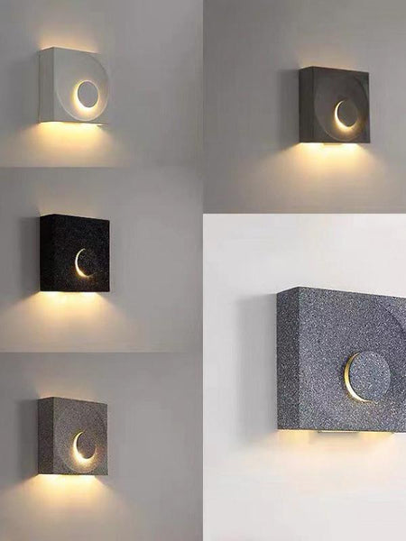 Close-up of Cave stone wall light's textured stone finish