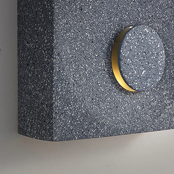 Cave stone wall light illuminated at night on an exterior wall