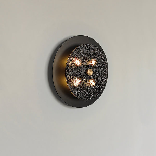 Renix black wall light with frosted glass shade mounted indoors
