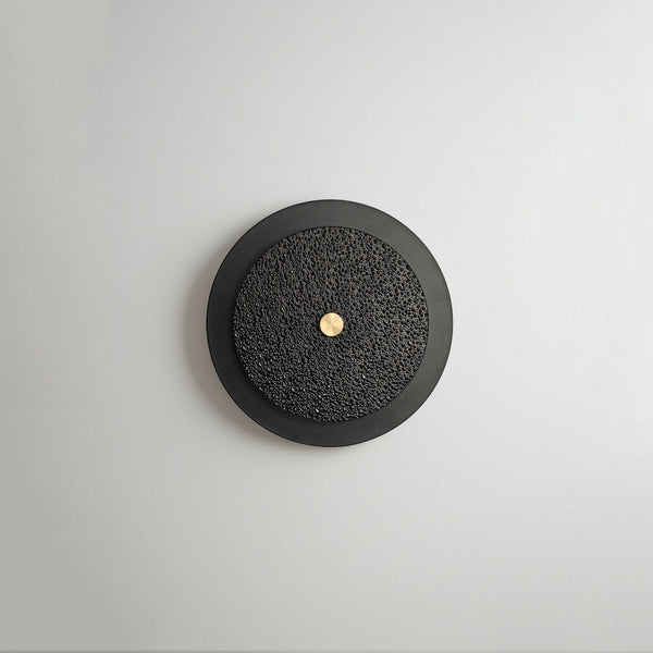 Close-up of Renix black wall light's frosted glass and iron finish