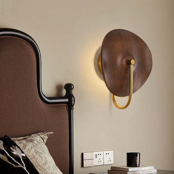 Solid wood wall light illuminated in a Nigerian living room