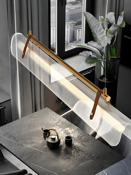 Niani gold pendant light illuminated in a modern interior