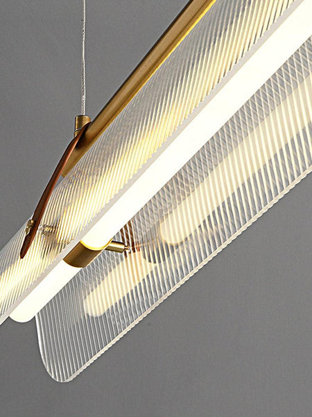 Close-up of Niani gold linear pendant's iron and acrylic design