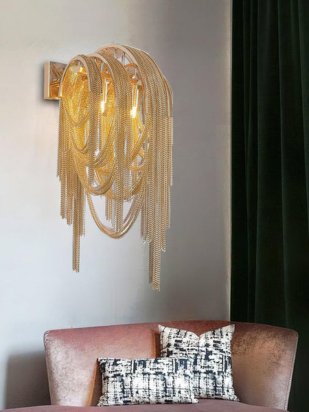 Tassel gold wall light in a living room setting