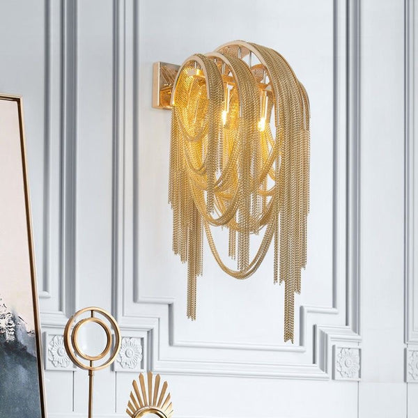 Close-up of Tassel gold wall light's Italian design