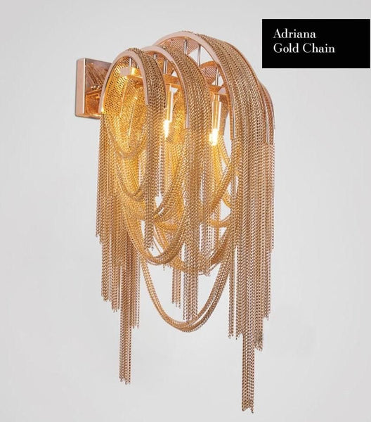 Tassel gold wall light illuminated with warm glow