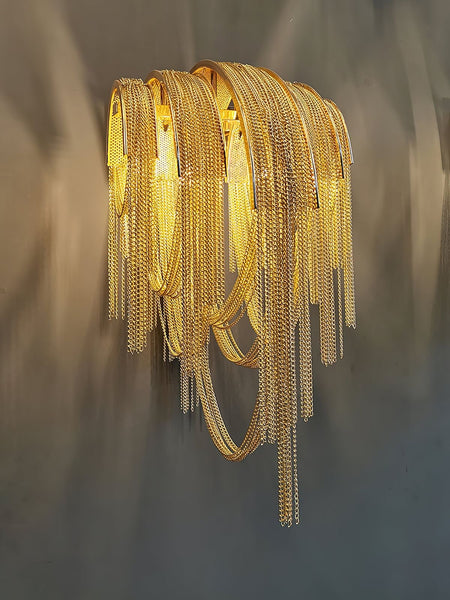 Tassel gold wall light mounted on a wall