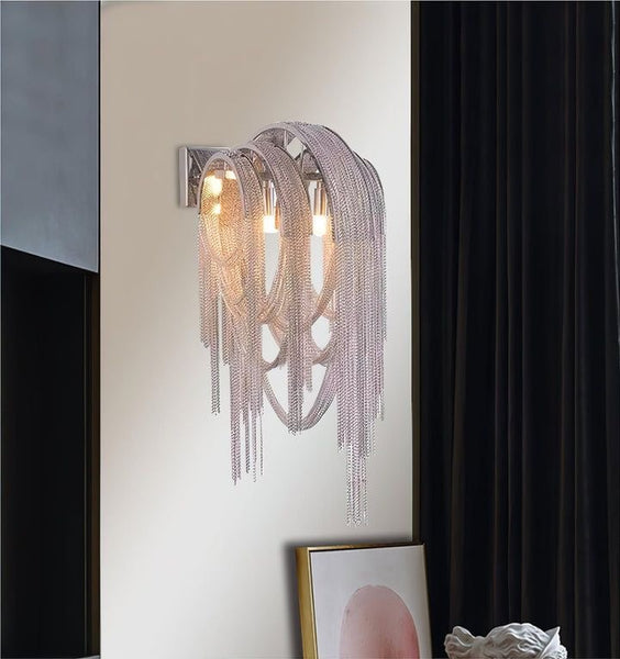 Tassel silver wall light illuminated with warm glow