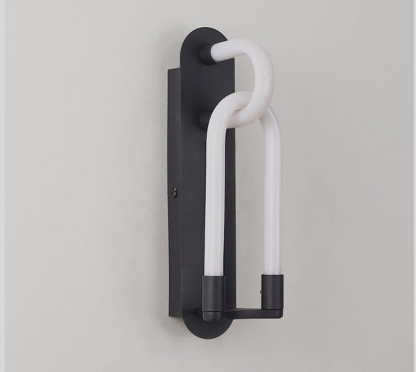 Loopi Knot wall light illuminated with warm glow