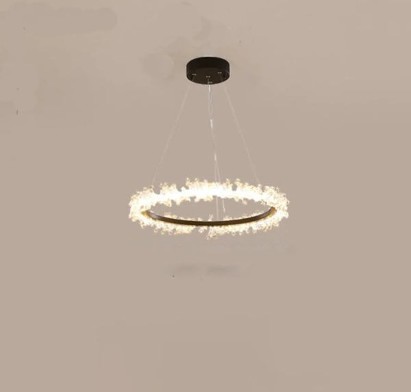 Beady black chandelier illuminated in a living room