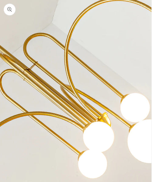 Gran Fontana gold chandelier hanging above a dining table