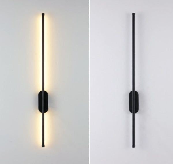 Linear black wall light mounted on a staircase wall