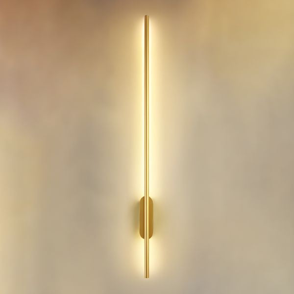 Linear bronze wall light mounted on a staircase wall