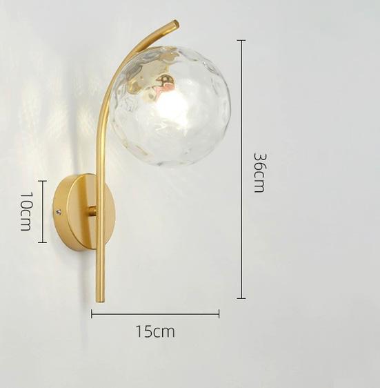 Miira Wall Light in gold mounted on a Nigerian living room wall