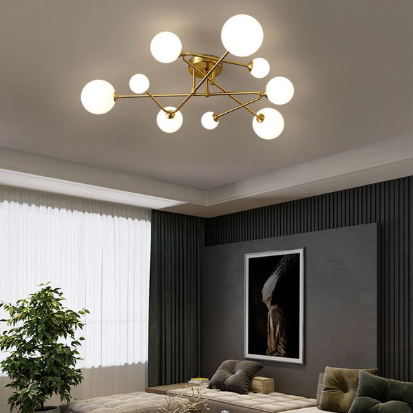 Postmodern Brass Ceiling Light with orb-shaped glass mounted on a Nigerian ceiling