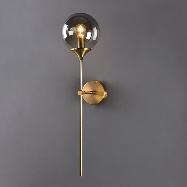 Luna Wall Light in gold mounted on a Nigerian stairway wall