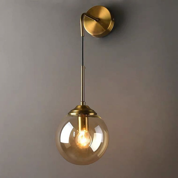 Nordic Wall Light in gold mounted on a Nigerian bedroom wall