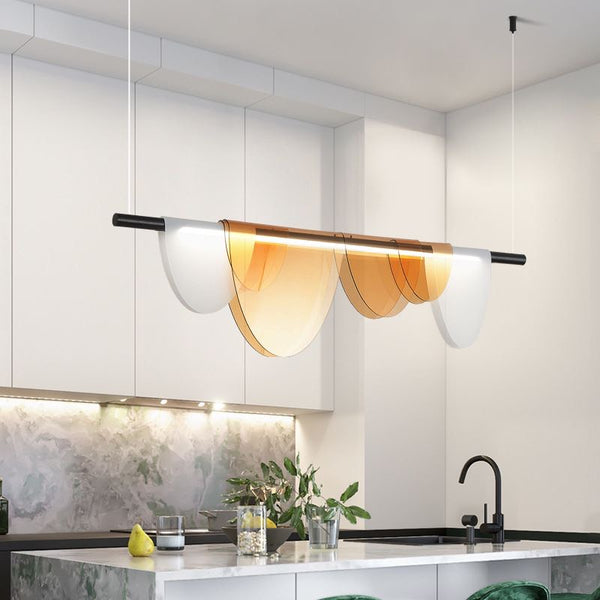 Light and Shadow gold chandelier installed above a dining table