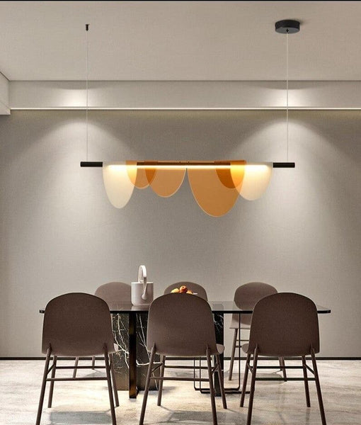 Light and Shadow gold chandelier with aluminium and glass frame in a Nigerian living room
