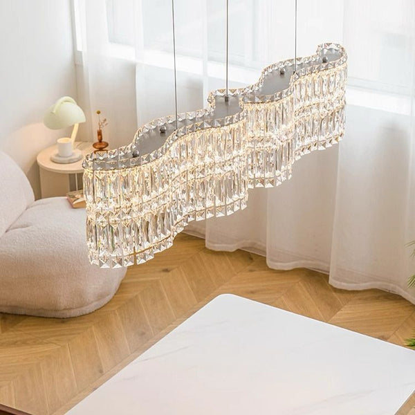 Halo Long Crystal Chandelier in chrome silver hanging above a dining table in Nigeria