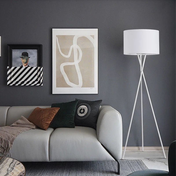 Crossed Nordic Floor Lamp styled beside a sofa in a Nigerian home