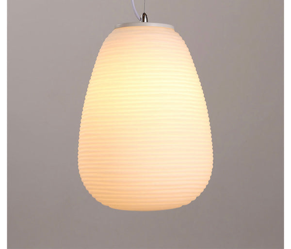 Nordic Threaded Chandelier with woven thread-like frame hanging above a dining table