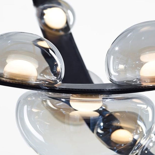 Spot Belt Glass Chandelier illuminated above a dining table in Nigeria