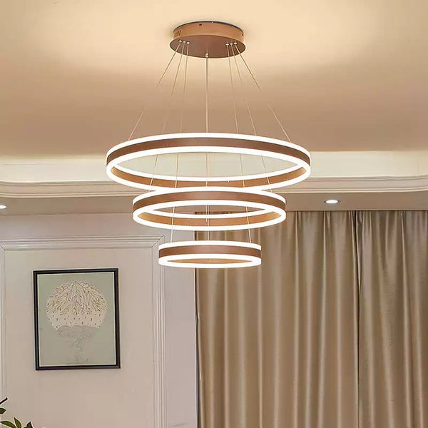 Brusque Circle Rings gold LED chandelier with layered circular rings in a Nigerian dining room