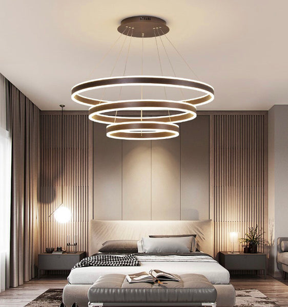 Brusque Circle Rings LED chandelier illuminated above a modern Lagos dining table