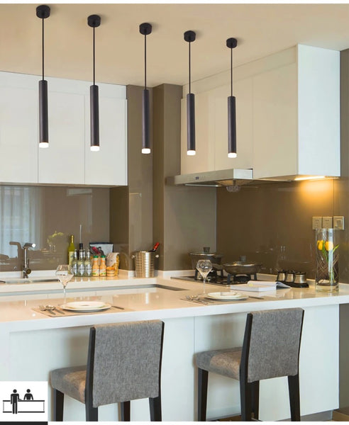 Criss Black Tube Light with matte black tubular frame above a kitchen island