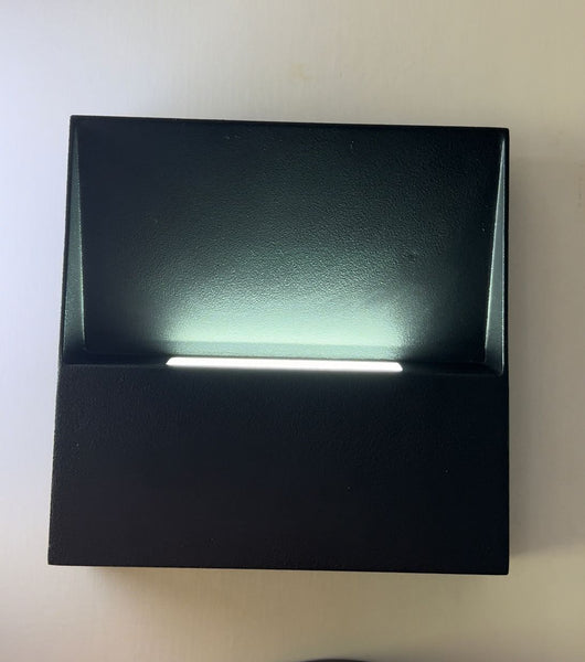 Outdoor wall light mounted along a compound perimeter wall in Nigeria