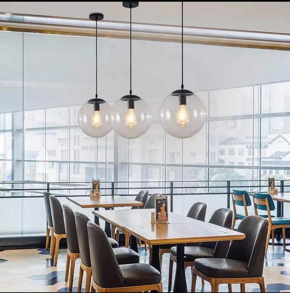 Glass Ball Drop Light cluster illuminated above a Nigerian kitchen island